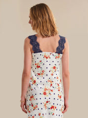 Woman wearing a floral dress with a lace neckline on a beige background