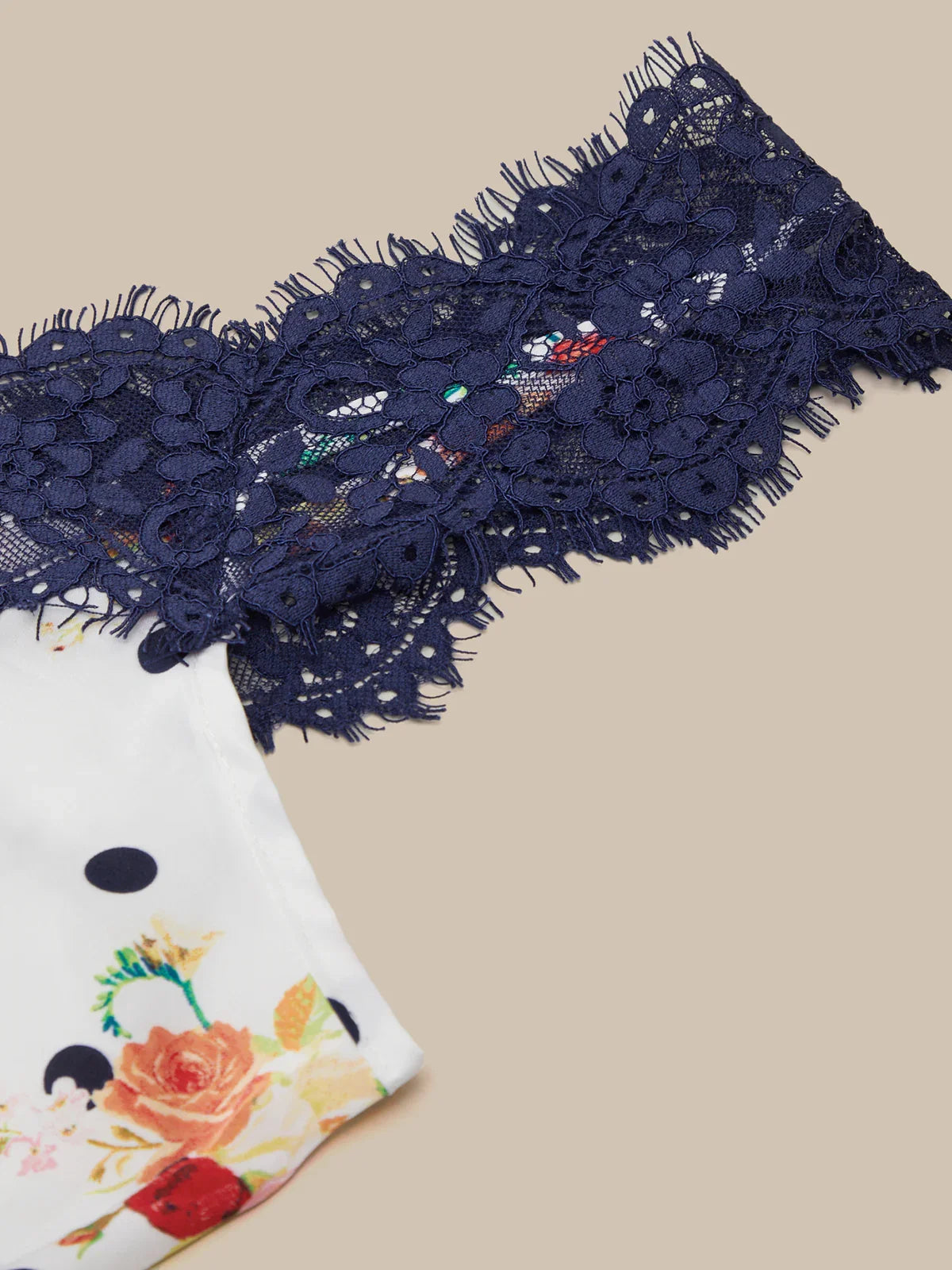 Navy blue lace trim on a beige background