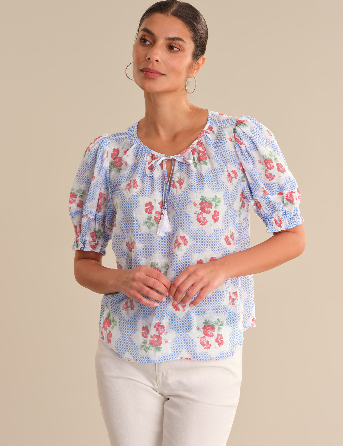 Woman wearing a floral blouse with a beige background