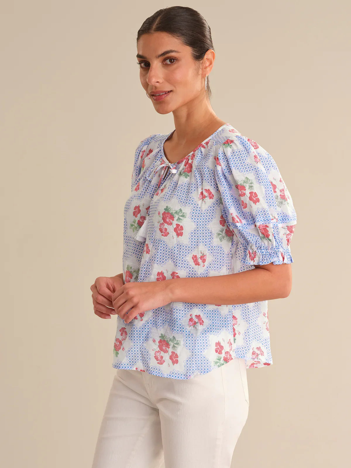 Woman wearing a floral blouse with a beige background