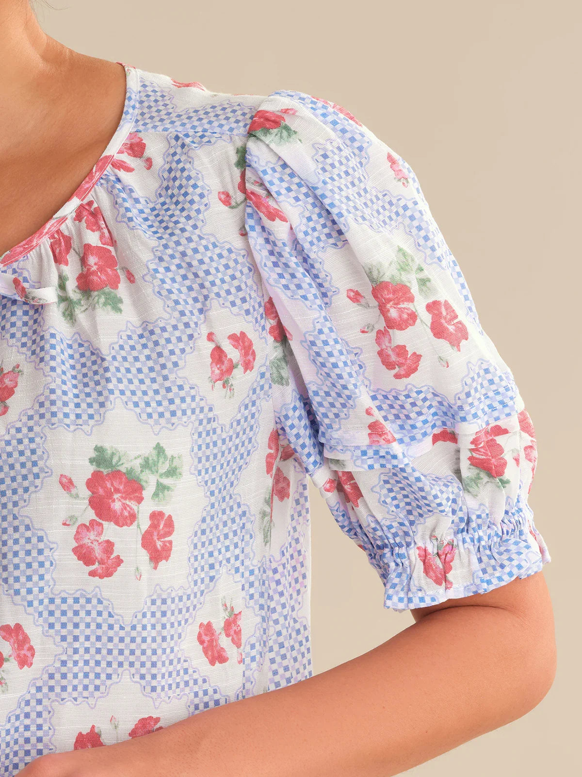 Floral patterned blouse with blue checkered background