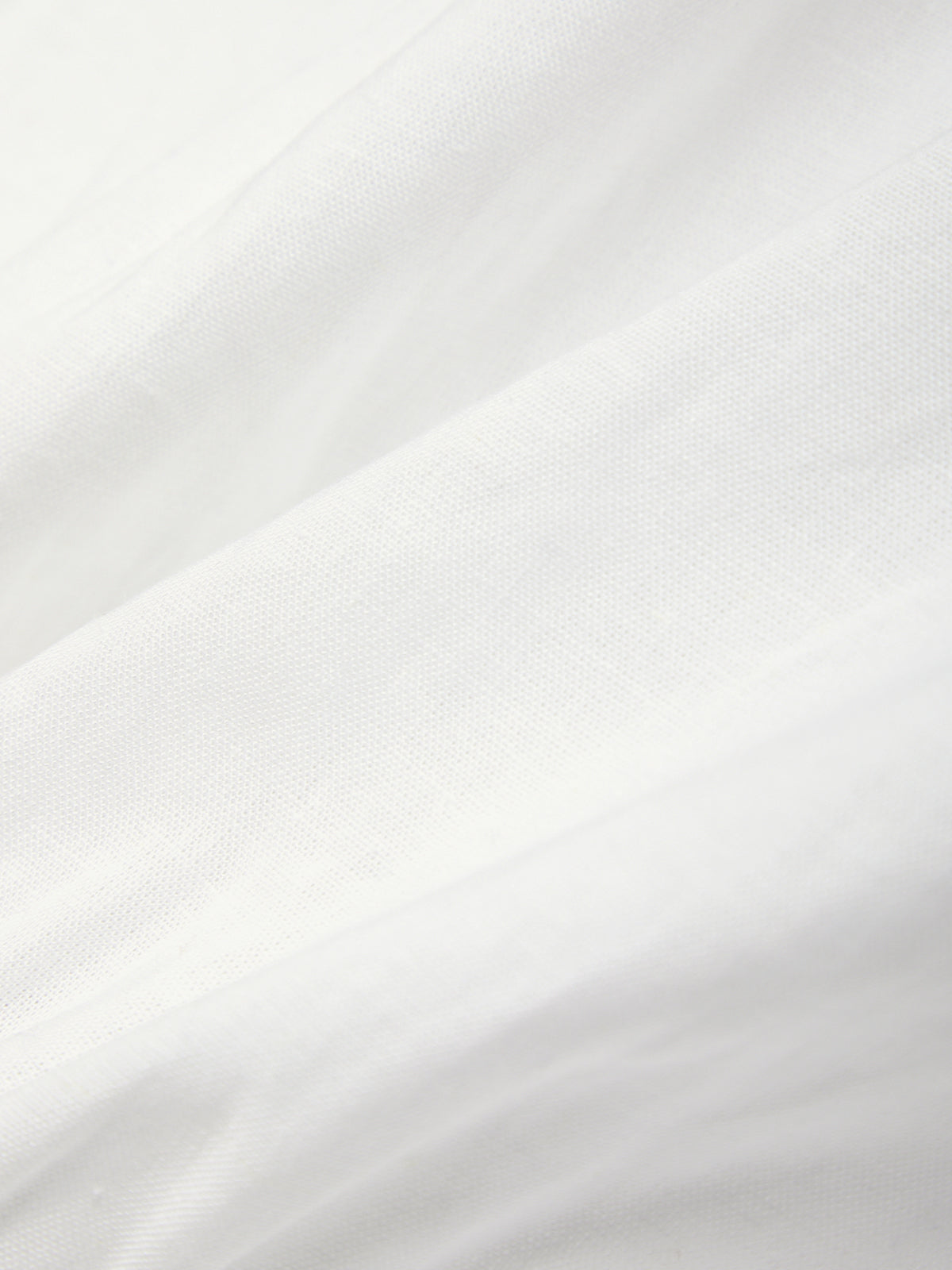 Close-up of white fabric with a subtle pattern
