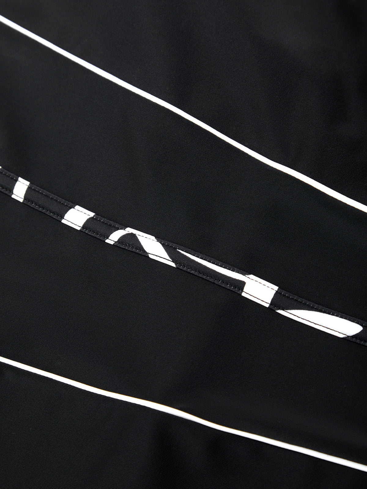 Close-up of a black fabric with white lines and patterns