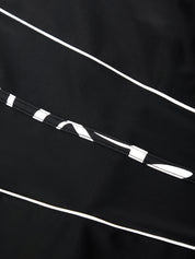 Close-up of a black fabric with white lines and patterns