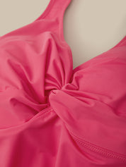 Close-up of a pink swimsuit top on a beige background