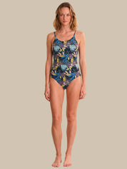 Woman wearing a floral-patterned swimsuit on a beige background