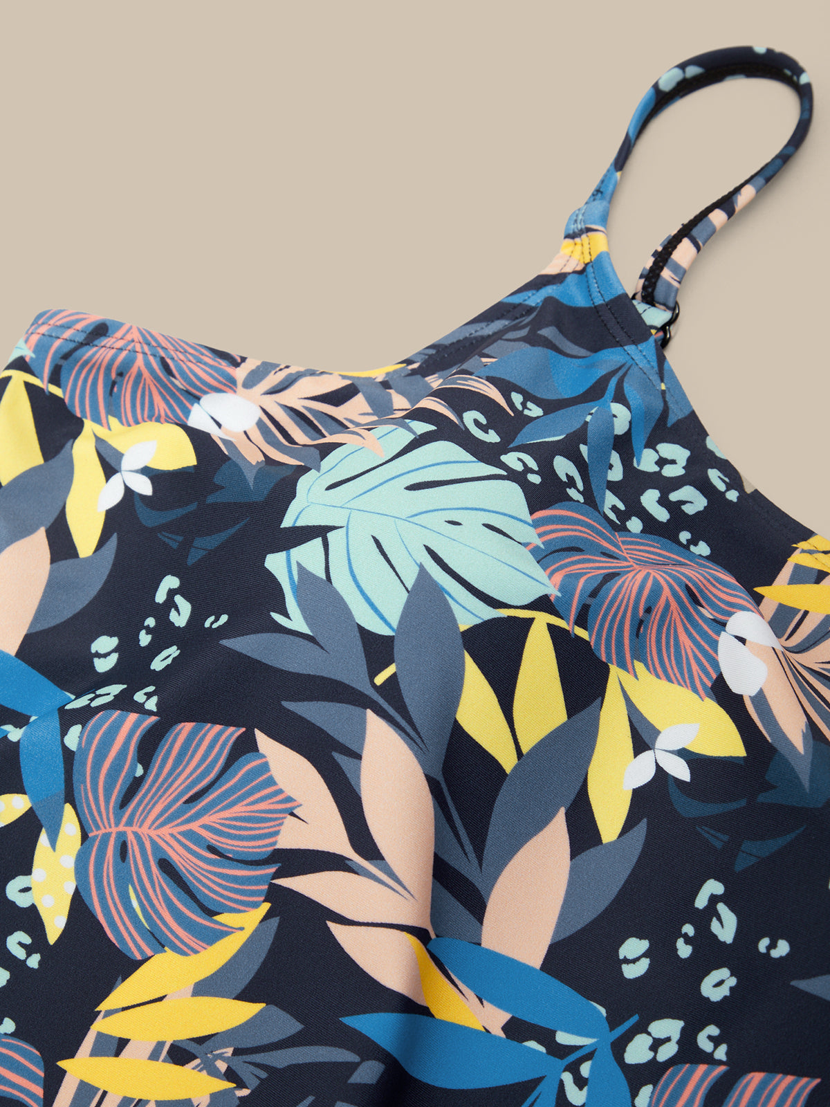 Floral patterned dress with colorful leaves on a beige background