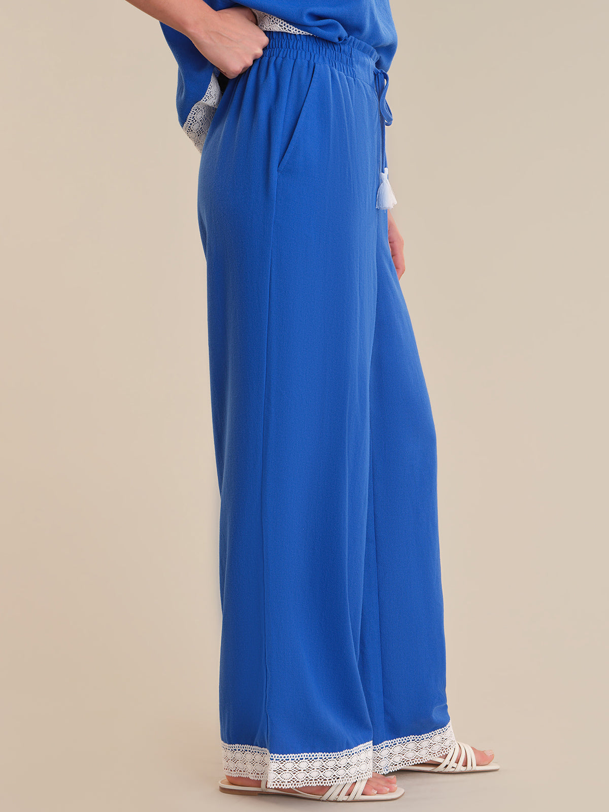 Blue dress with lace trim on a beige background