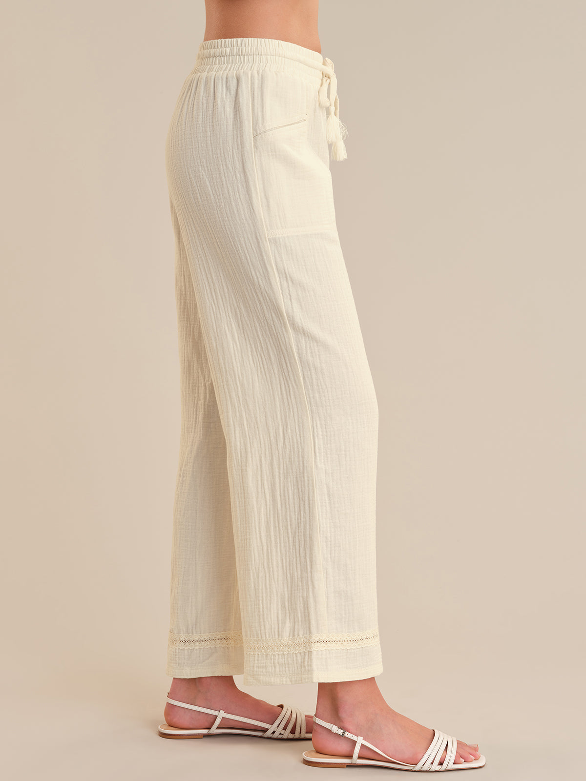 Beige pants worn by a person on a beige background