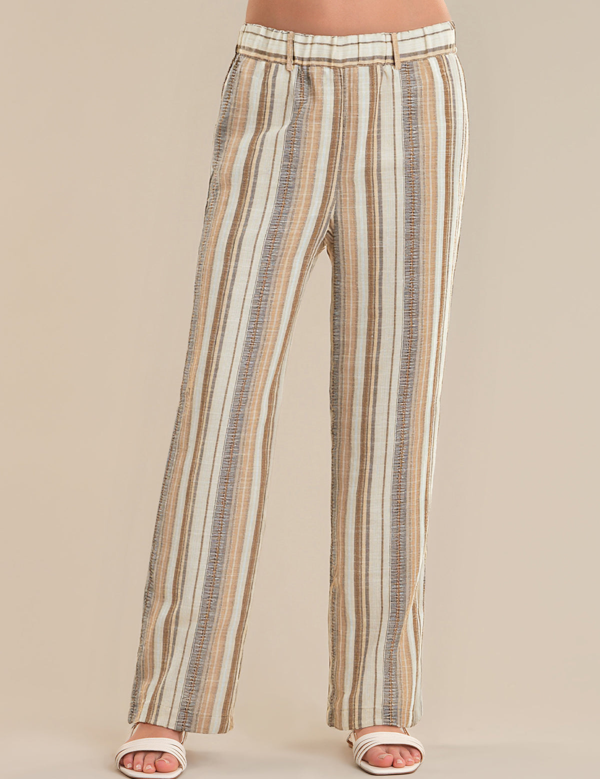 Striped pants worn by a person on a beige background