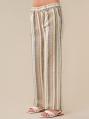 Striped pants worn by a person on a beige background