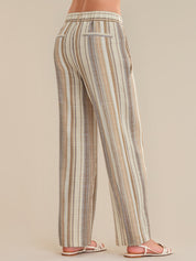 Striped pants worn by a person on a beige background