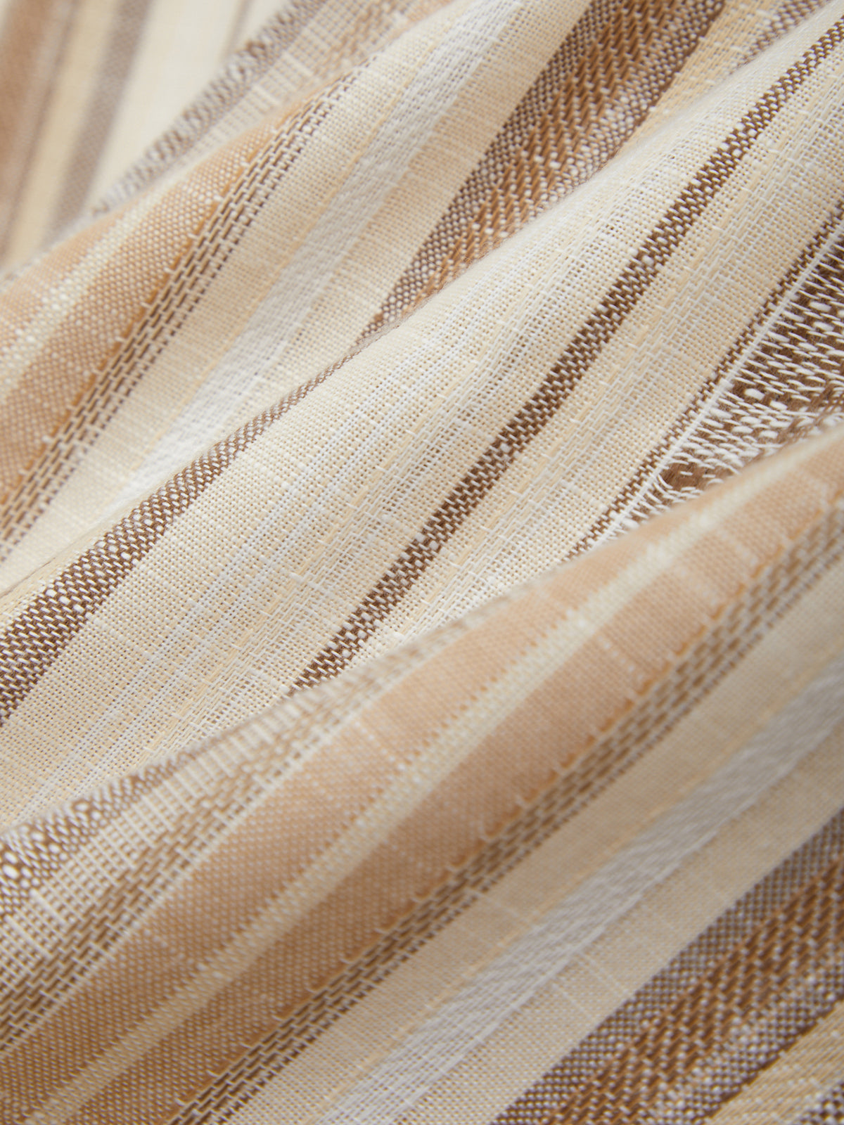Close-up of striped fabric with beige and brown colors