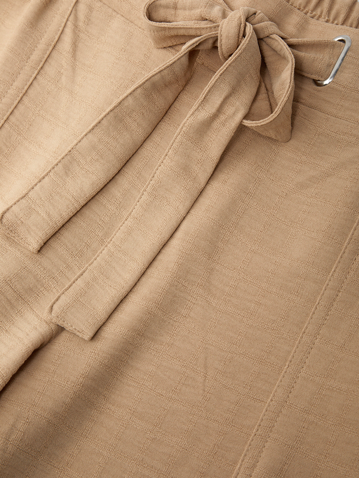 Close-up of a beige fabric with a tie detail