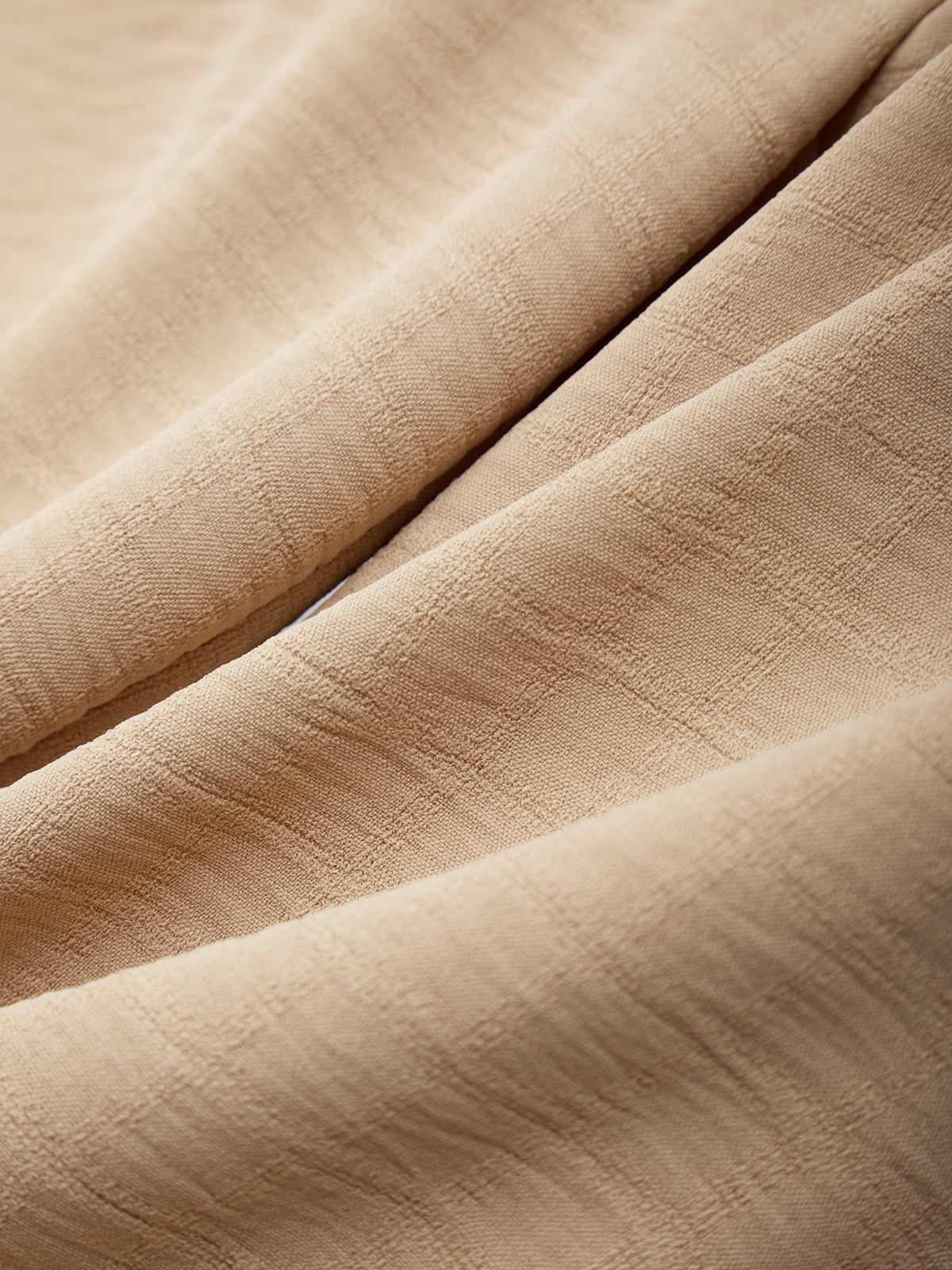 Close-up of beige fabric with visible texture