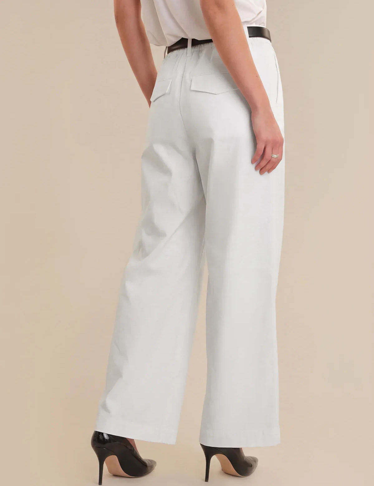 Light blue wide-leg pants worn by a person on a beige background
