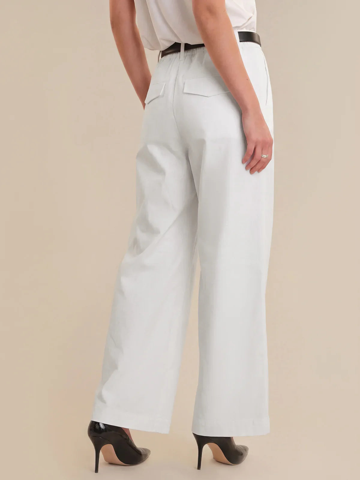 Light blue wide-leg pants worn by a person on a beige background