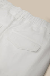 Light gray pants with a pocket on a beige background