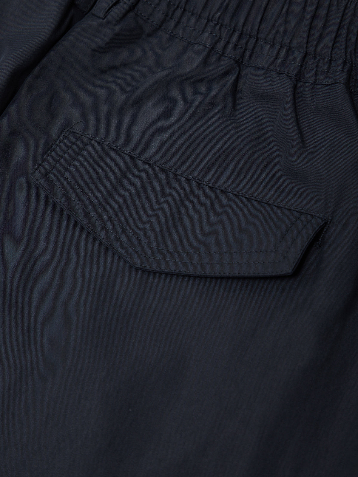 Close-up of a navy blue fabric with a pocket detail