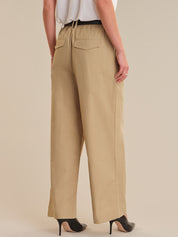 Beige wide-leg pants worn by a person on a beige background