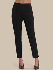 Black pants worn by a person on a beige background