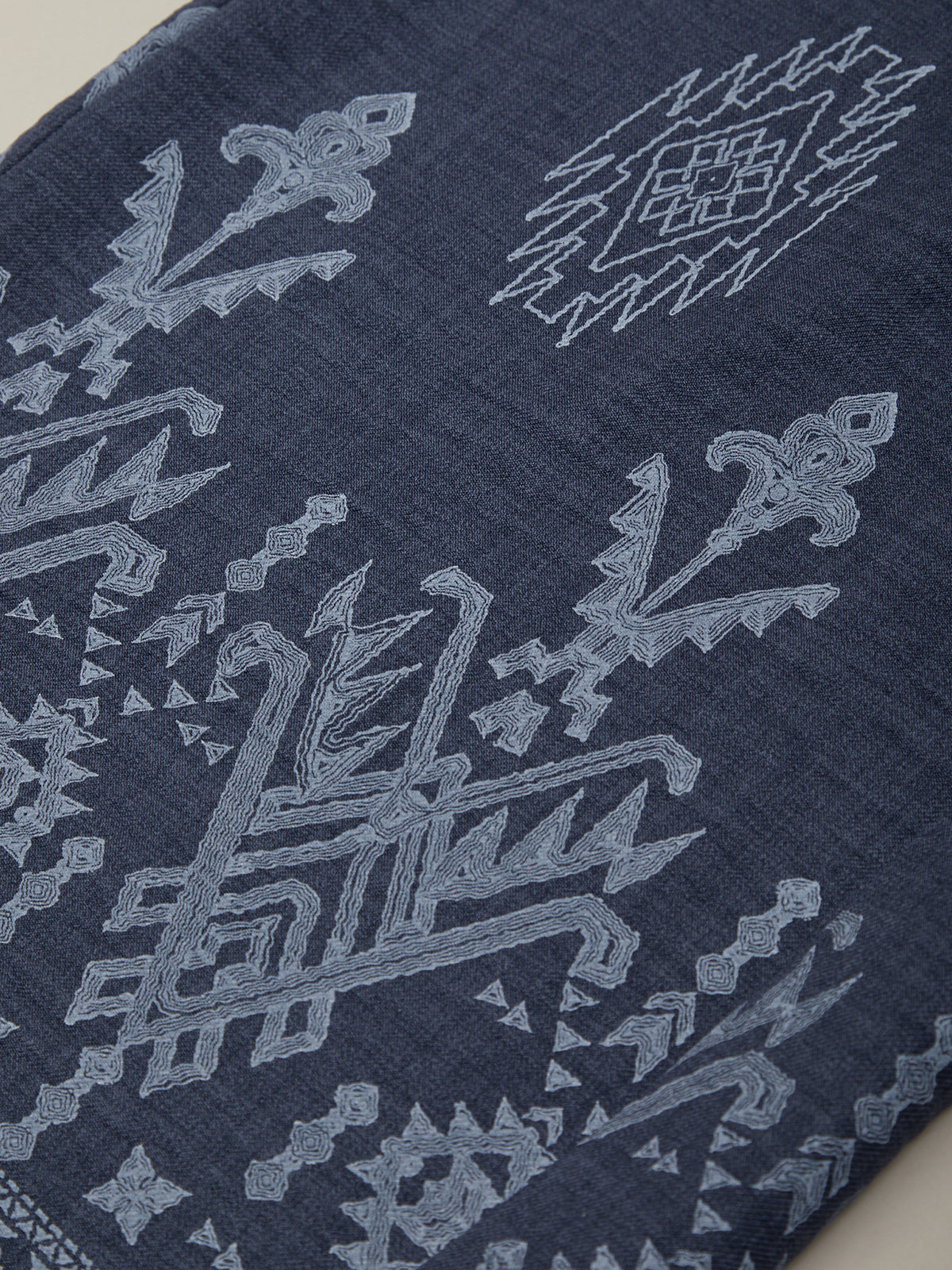 Navy blue fabric with intricate white geometric patterns