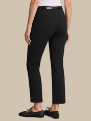 A model shown from the back wearing black cropped trousers with a matching black belt, paired with black leather flats, against a solid beige background.