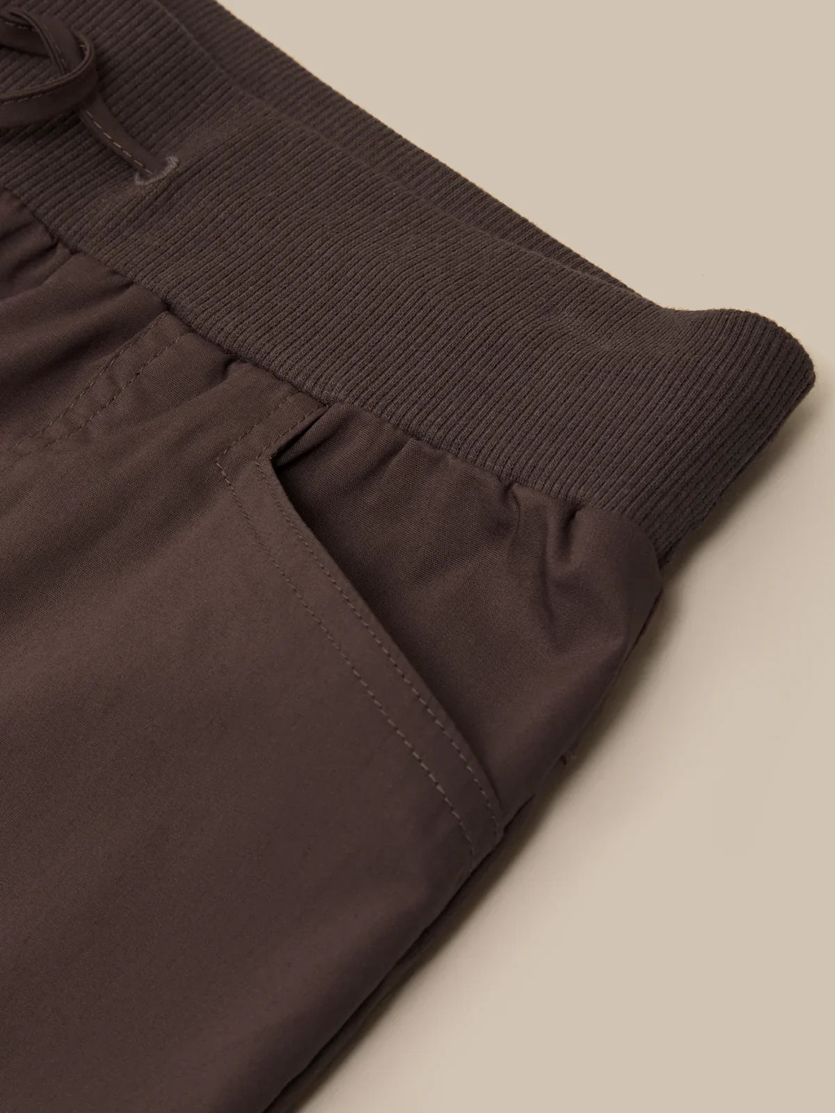 Brown ribbed knit sweater with a plain background