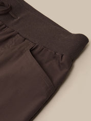 Brown ribbed knit sweater with a plain background