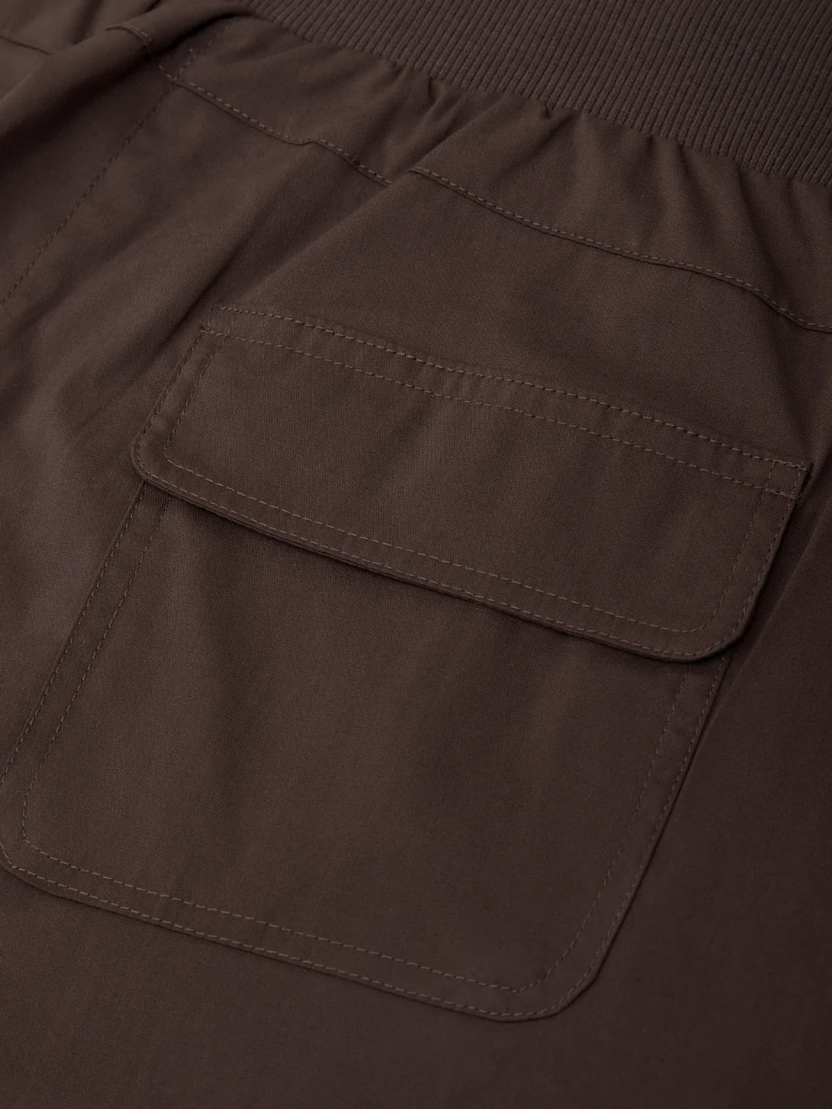 Close-up of a brown jacket with a pocket