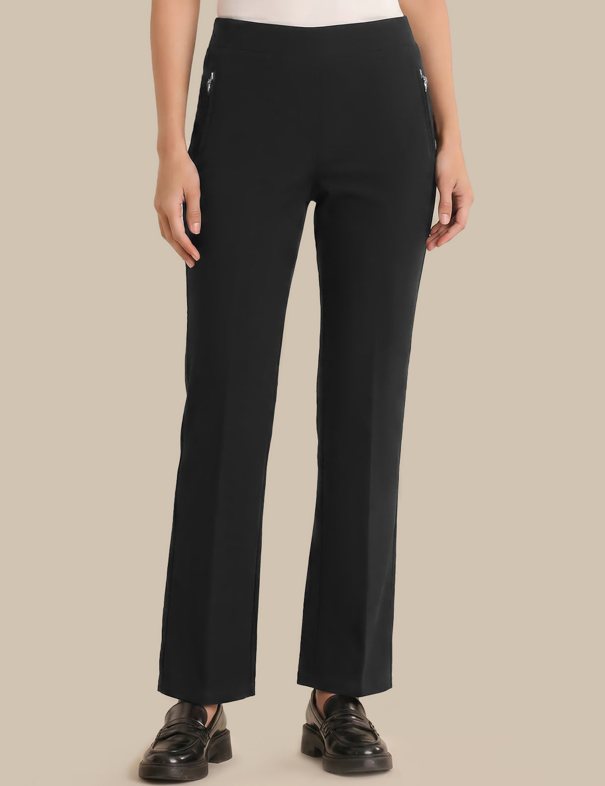Person wearing black pants on a beige background