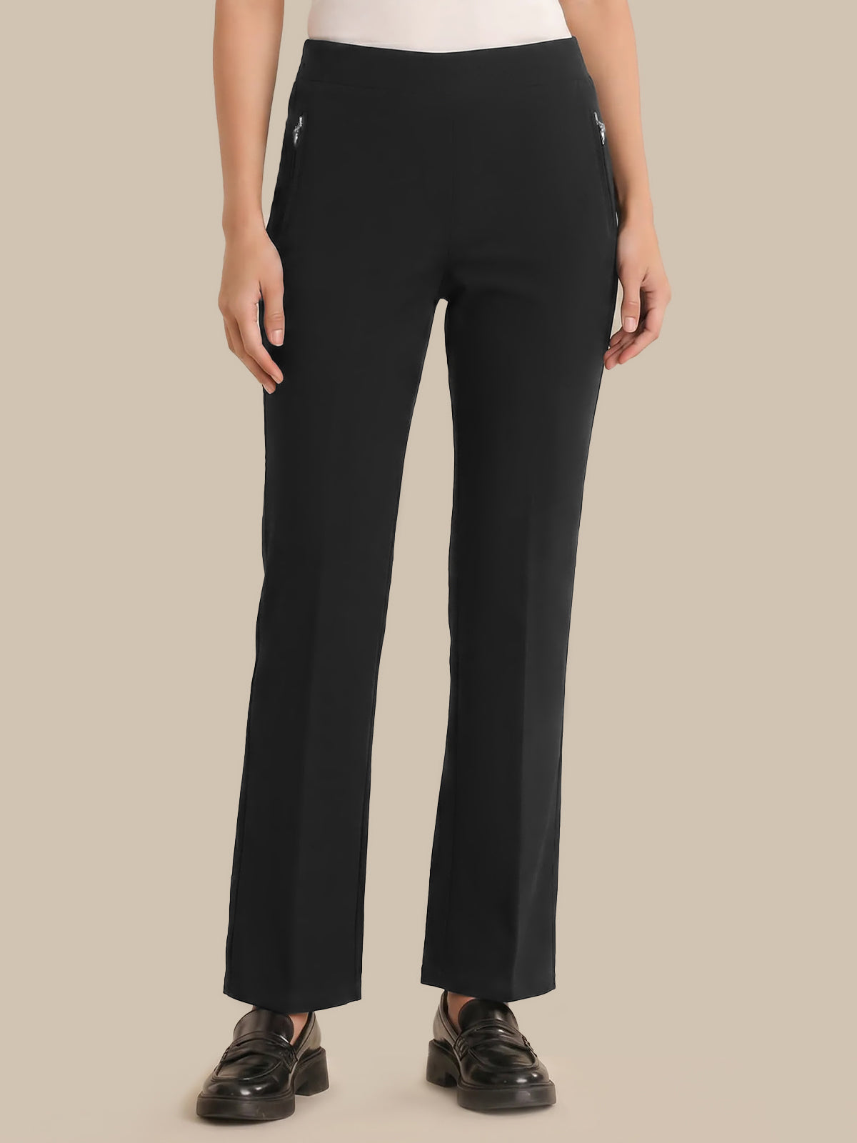Person wearing black pants on a beige background