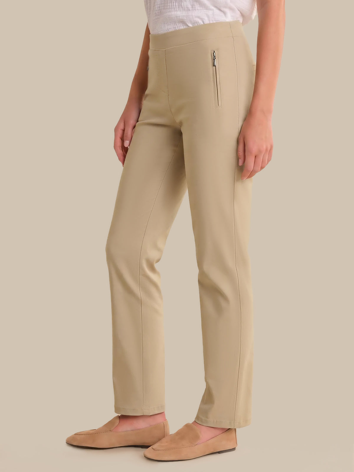 Beige pants worn by a person on a beige background