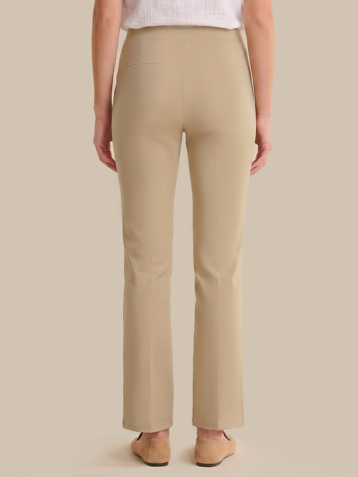 Beige pants worn by a person on a beige background