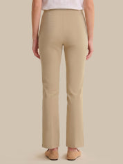 Beige pants worn by a person on a beige background