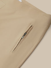 Beige pants with a zipper detail on a beige background