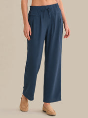 Person wearing blue pants on a beige background