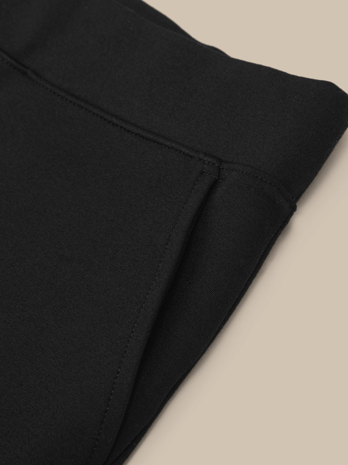 Close-up of black fabric on a beige background