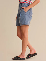Denim skirt worn by a person on a beige background