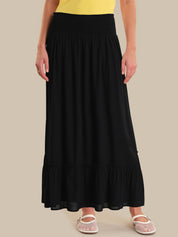 Person wearing a black skirt on a beige background