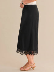 Black skirt with lace hem on a beige background