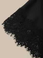 Close-up of black lace fabric on a beige background