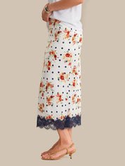 Floral polka dot skirt with lace trim worn by a person on a neutral background