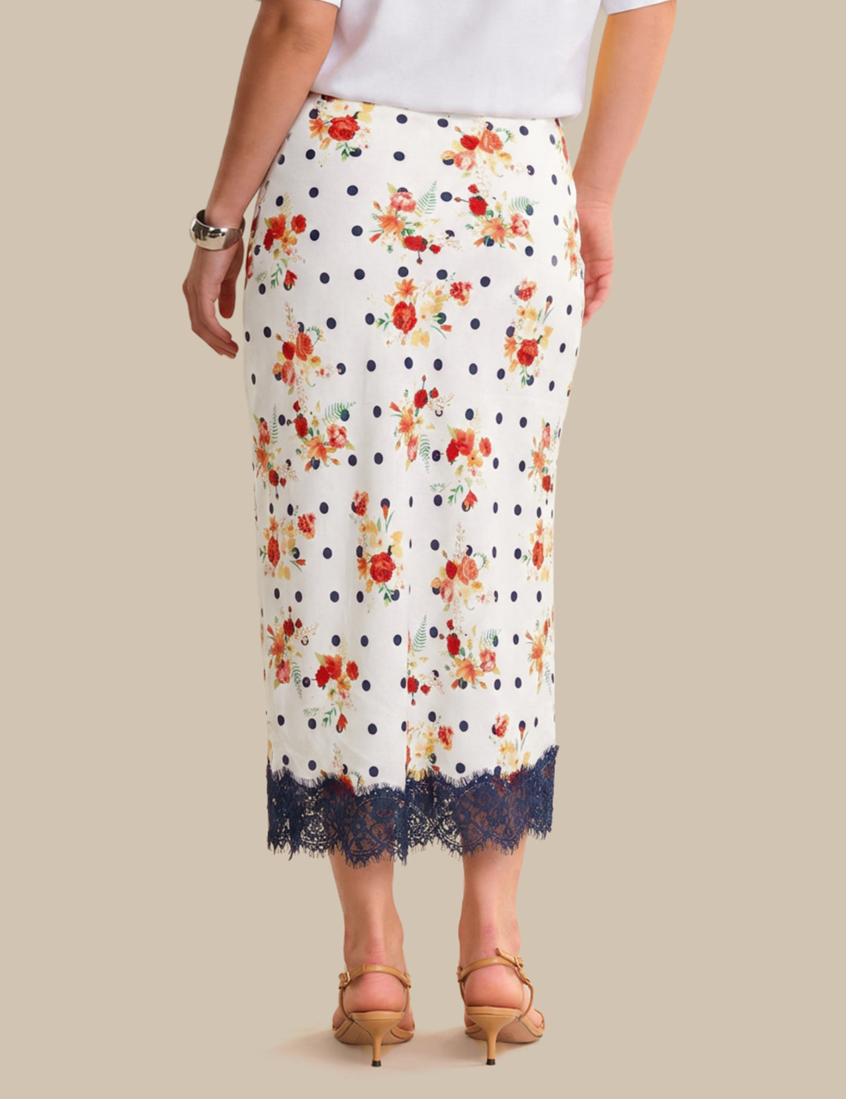 White skirt with floral pattern and lace trim on a neutral background