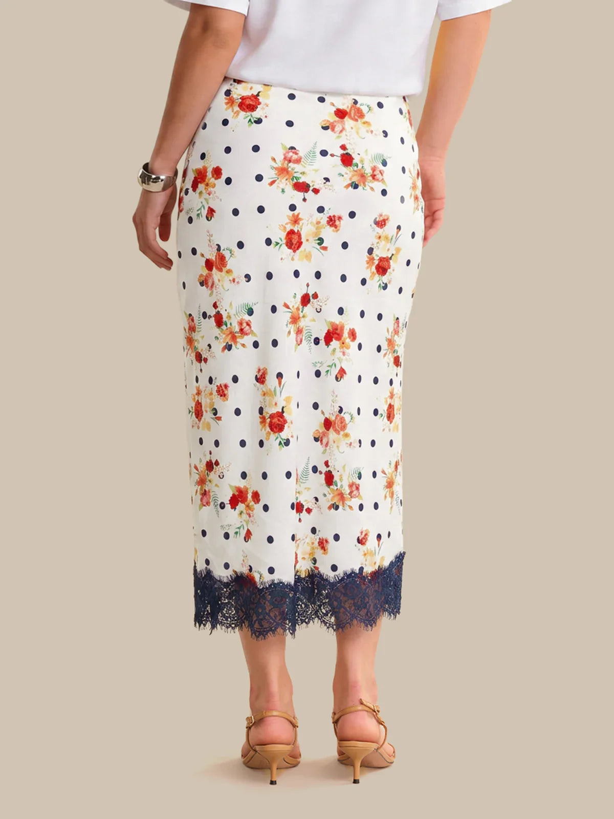 White skirt with floral pattern and lace trim on a neutral background