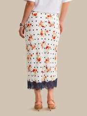 White skirt with floral pattern and lace trim on a neutral background