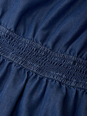 Close-up of a blue fabric with smocked waistband