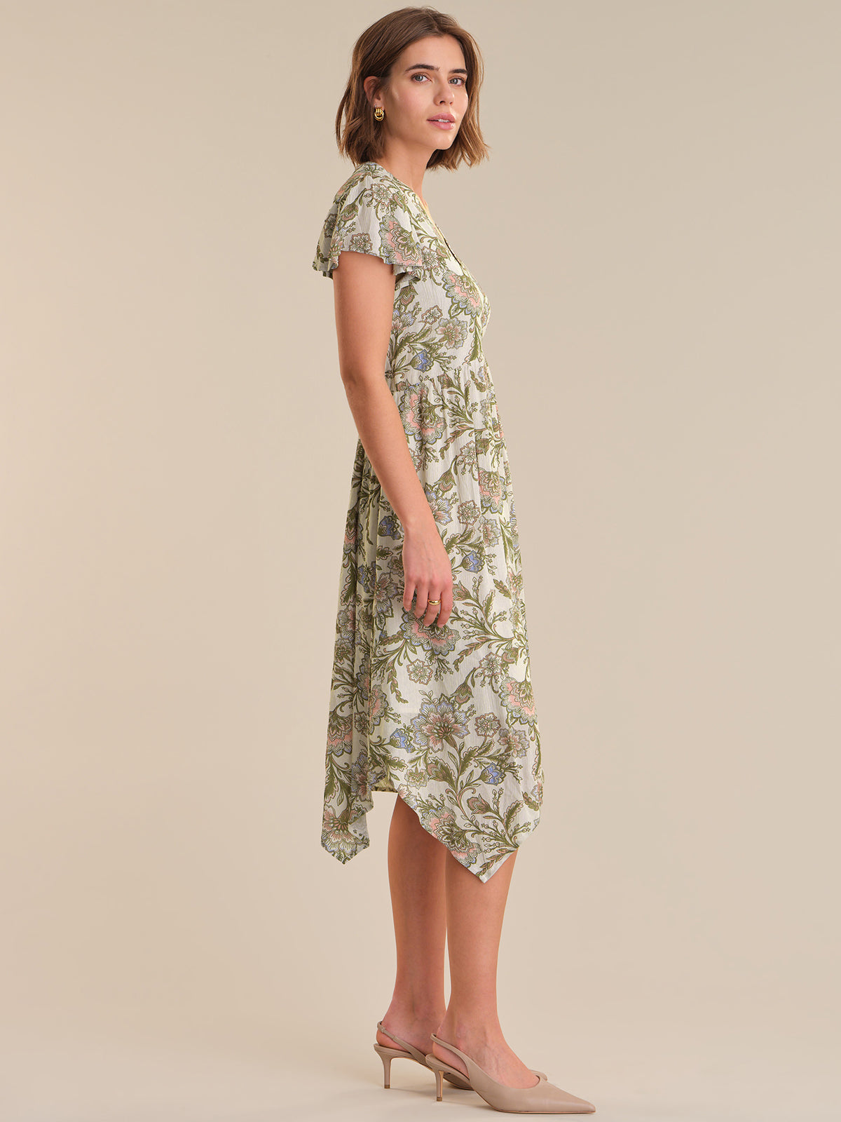 Woman wearing a floral dress on a beige background
