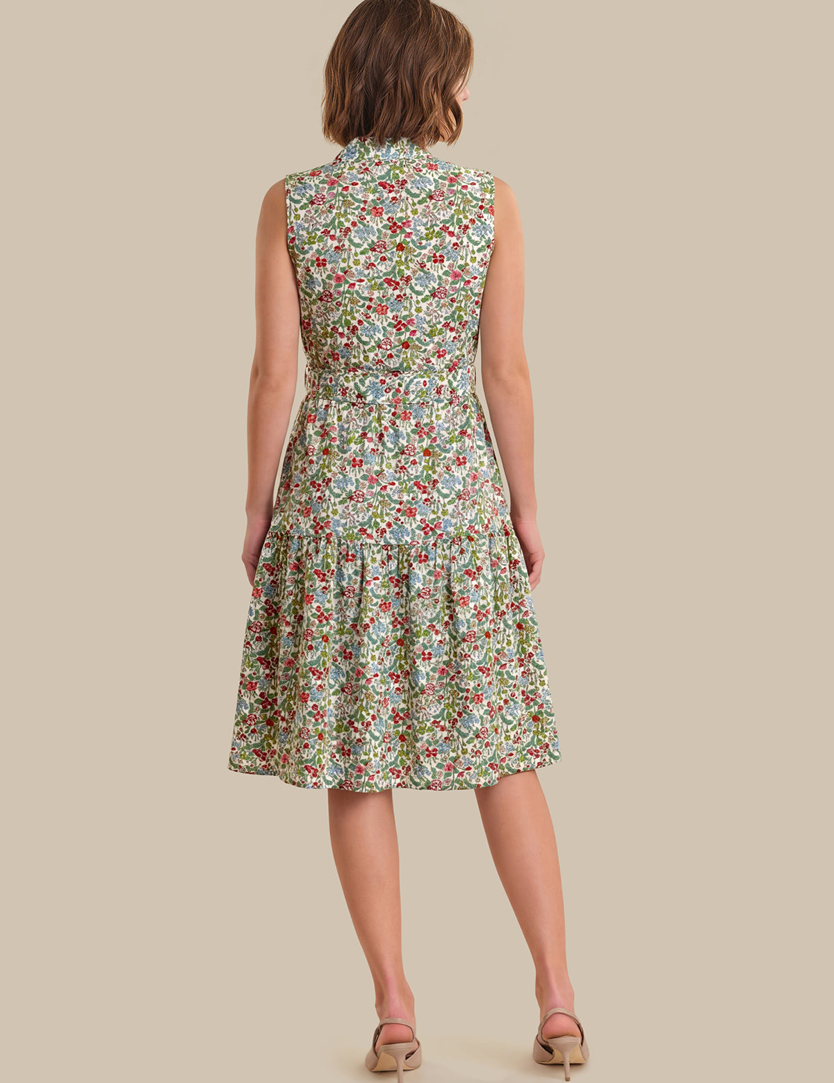 Woman wearing a floral dress on a beige background