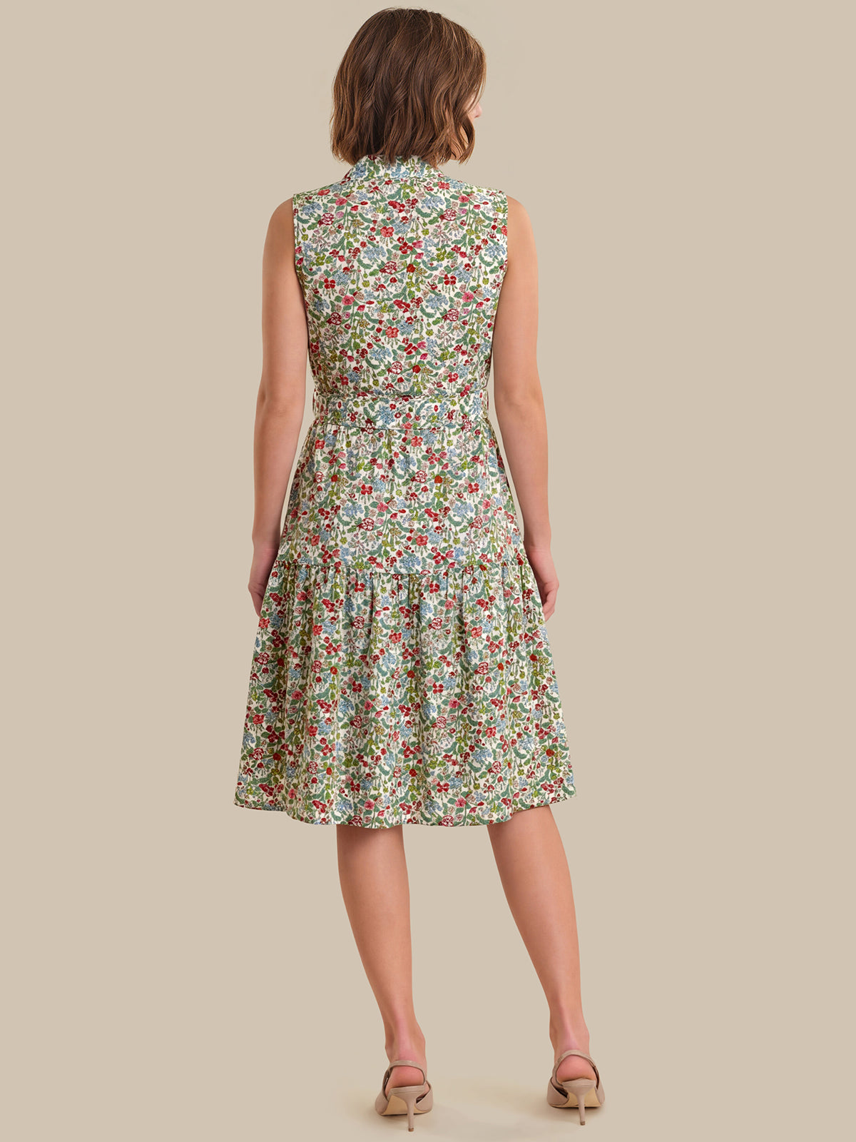 Woman wearing a floral dress on a beige background